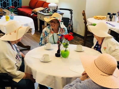 Residents enjoying a social activity at a table.