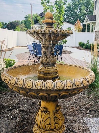 A decorative outdoor fountain in a garden space.