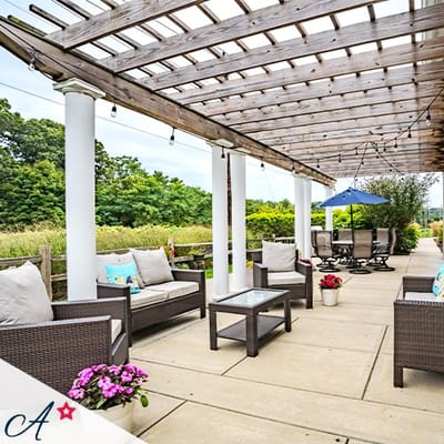 Outdoor seating area with comfortable furniture and flowers