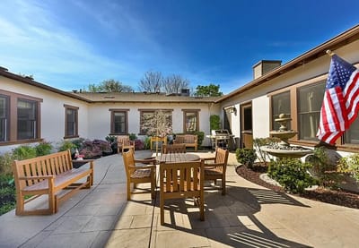 Outdoor patio area with seating and an American flag