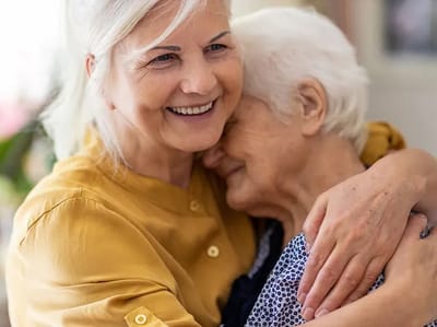 Caregiver embracing an elderly resident in a warm moment