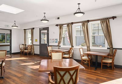 Bright common area with wooden tables and chairs