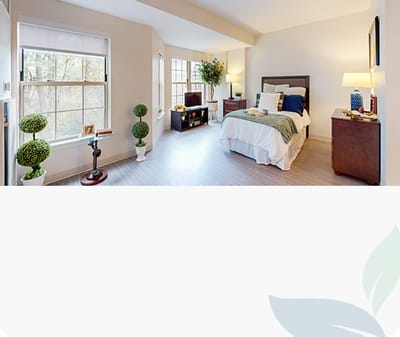 Brightly lit private resident room with decor.
