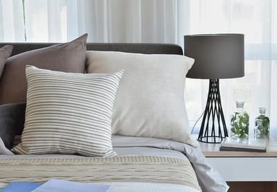 Stylish bedding and decor in a cozy room