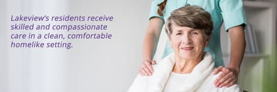 Senior woman smiling with caregiver in background