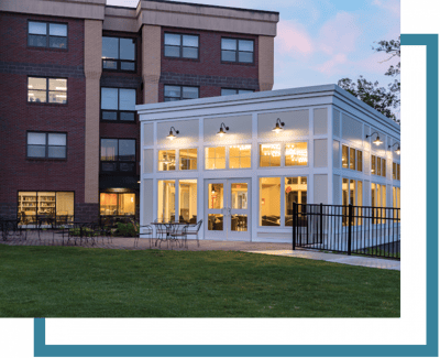 Exterior view of a senior living facility with a sunroom