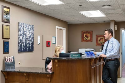 Reception area with staff attending to a resident
