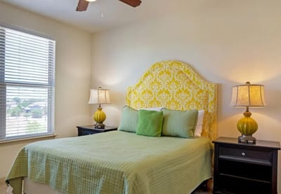 Cozy bedroom with a decorative headboard and lamps