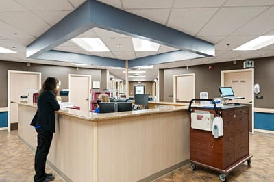 Staff at reception in a well-lit facility interior