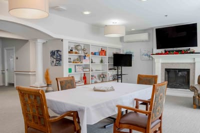 Bright interior common area with a fireplace and seating