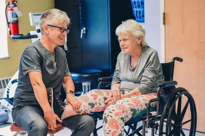 Staff assisting a resident in a therapy session