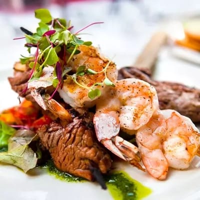 Close-up of a gourmet meal with shrimp and steak