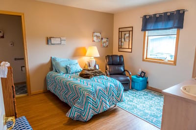 Private resident room with a bed and seating area