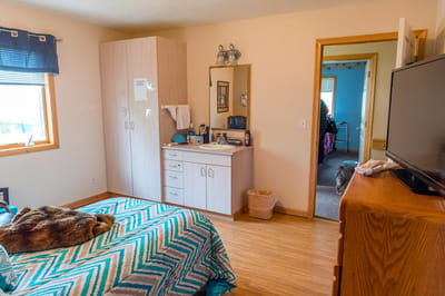 Cozy private resident room with a bed and dresser