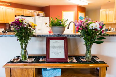 Decorative table with flowers and a framed message