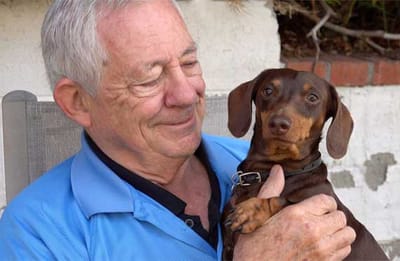 Resident enjoying time with a dog outdoors