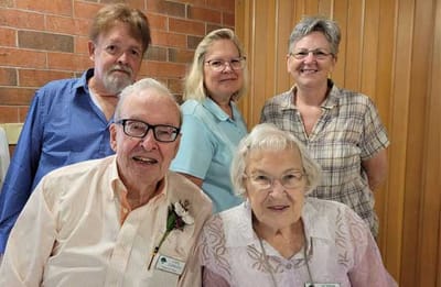 Residents and staff posing together in a common area
