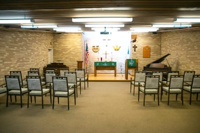 Interior view of a multi-purpose room with chairs and musical instruments