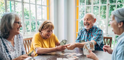 Gardens at Ridgecrest Village, nursing home in Davenport, IA — Seniors enjoying a card game at a table