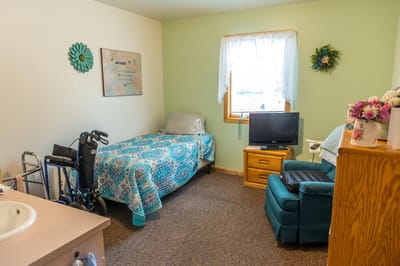Private resident room with a bed and seating area