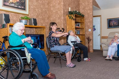 Staff engaging with residents in an activity room