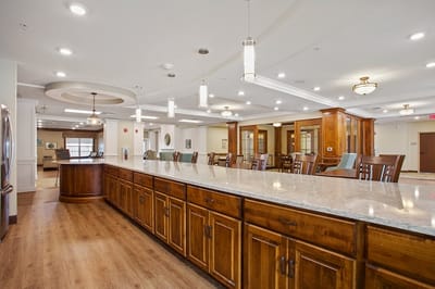 Bright common area with seating and a kitchen island
