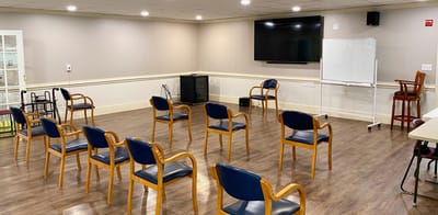 Interior activity room with chairs arranged in a circle