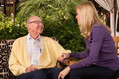 A resident and staff member enjoying a conversation outdoors