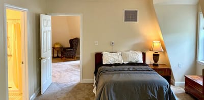 A private resident room with a bed and chair