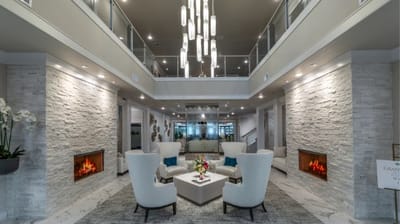 Modern lobby area with seating and fireplace