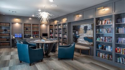 Cozy library area with seating and shelves