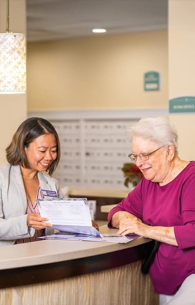 Staff assisting a resident at the front desk