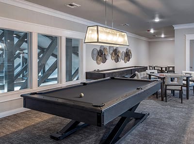 Interior view of a recreational common area with a pool table