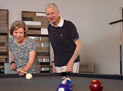 Residents playing billiards in a common area