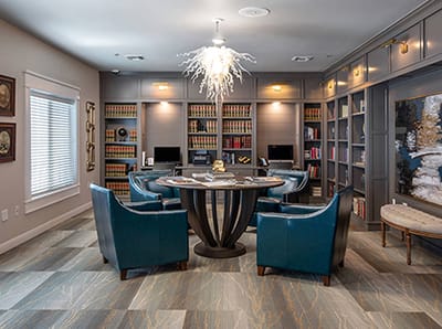 Interior view of a cozy common area with seating and bookshelves