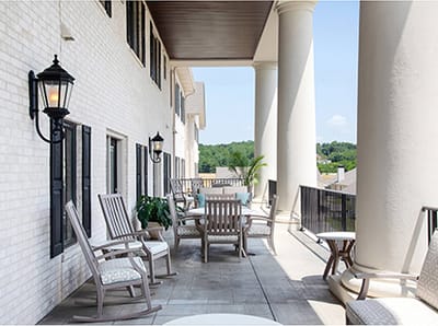 Outdoor seating area with rocking chairs and plants