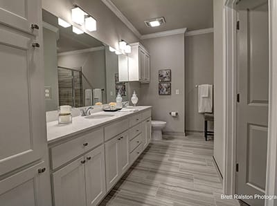 Modern bathroom with white cabinets and bright lighting