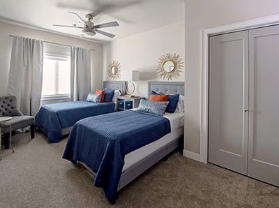 A bright, cozy resident room with two twin beds