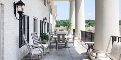 Outdoor seating area with chairs and plants