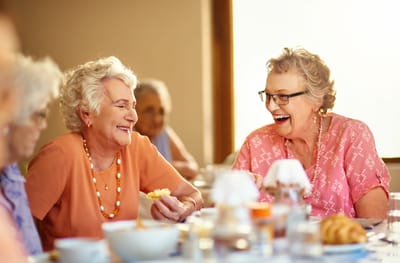 Residents enjoying a meal together in a dining area
