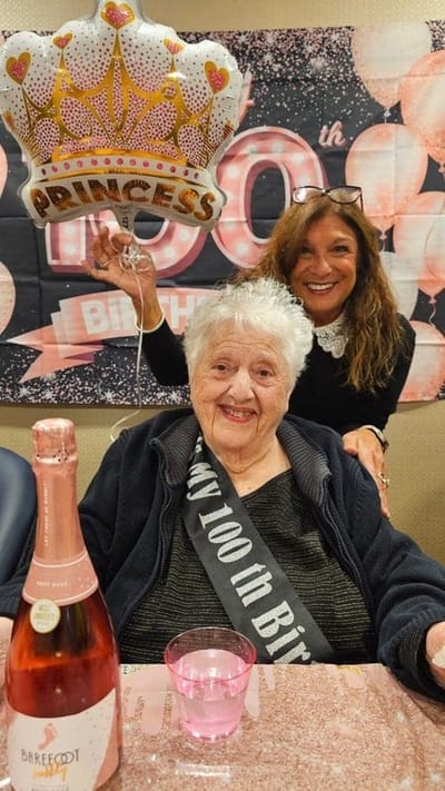 Residents celebrating a 100th birthday with decorations