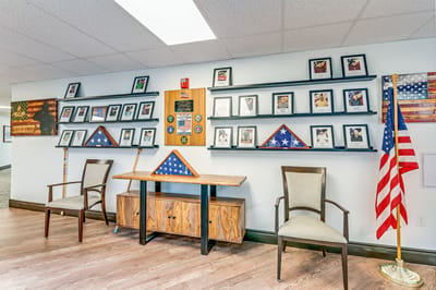 Indoor common area with military memorabilia and flags