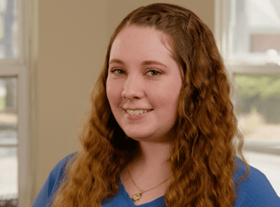 Smile of a resident staff member in an indoor setting