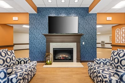 Bright common area with fireplace and seating