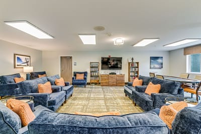 Bright common area with sofas and bookshelves