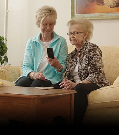 Two residents engaging in conversation in a cozy sitting area