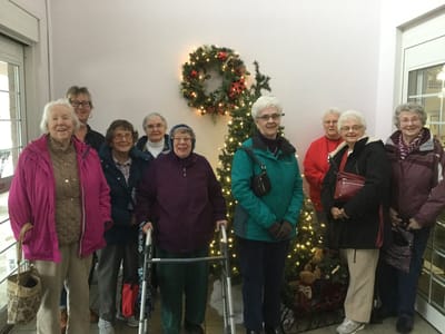Residents celebrating together around a decorated tree