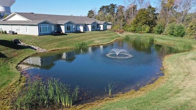 Aerial view of a serene pond and resident buildings