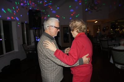 Residents dancing at an indoor celebration event