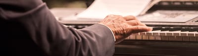 A hand playing the piano during an event